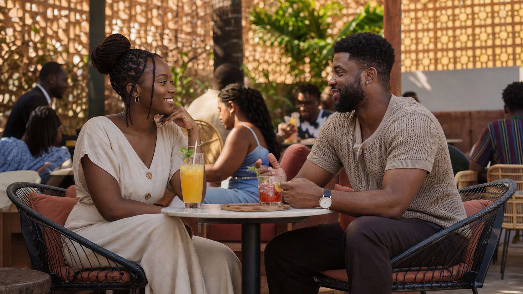 Two adults having a relaxed conversation at an outdoor setting in Accra